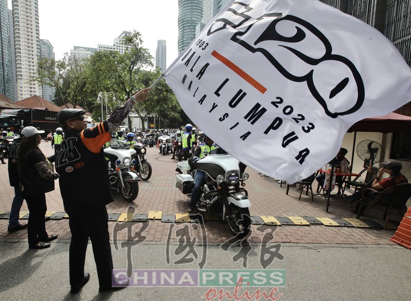 ▲慕沙(左)为“哈雷戴维森120周年纪念吉隆坡站”摩哆巡游主持挥旗仪式。